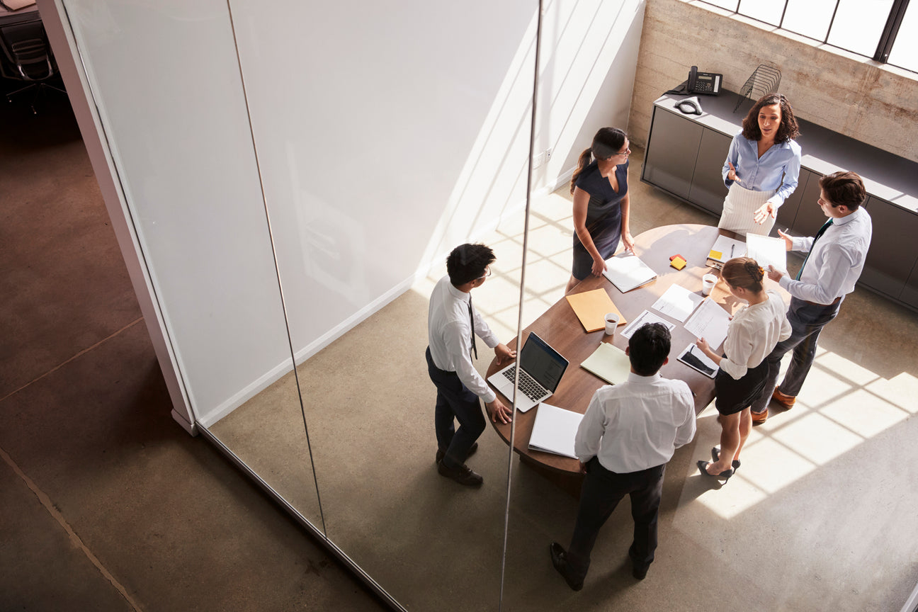 Colleagues discussing ideas around a table